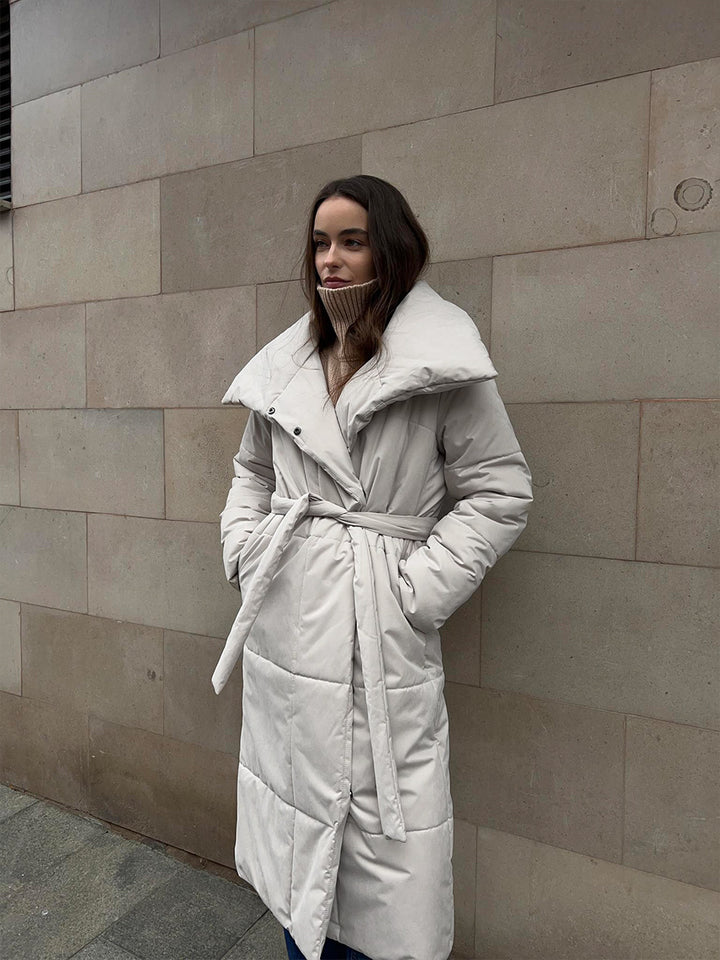 Woman in a long quilted belted coat