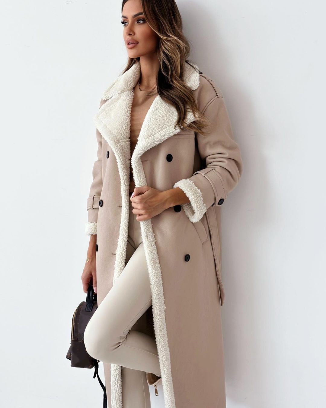 Woman in a belted faux shearling coat