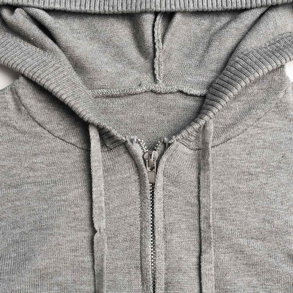 Woman in ribbed knit hoodie and flare pants set