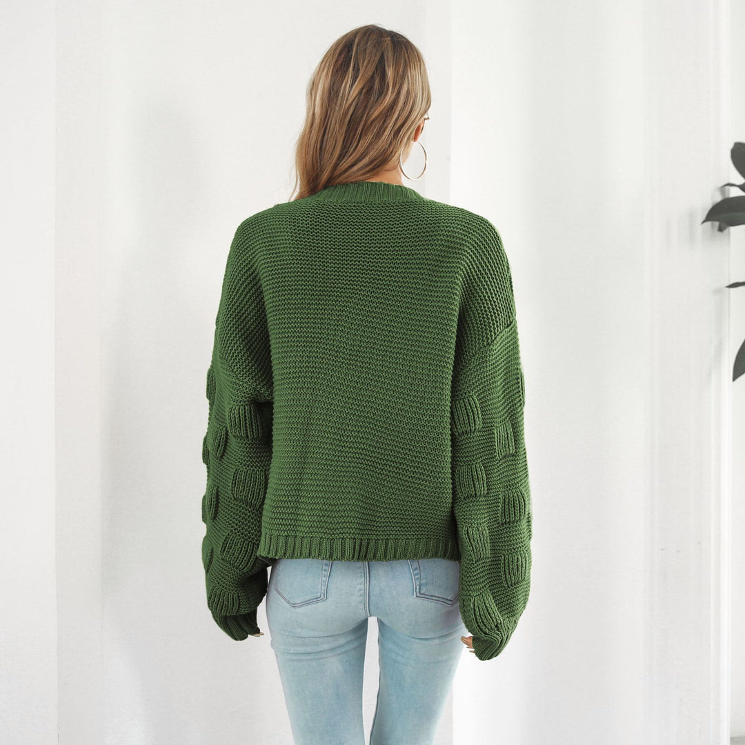 Woman in chunky cable knit puff sleeve cardigan