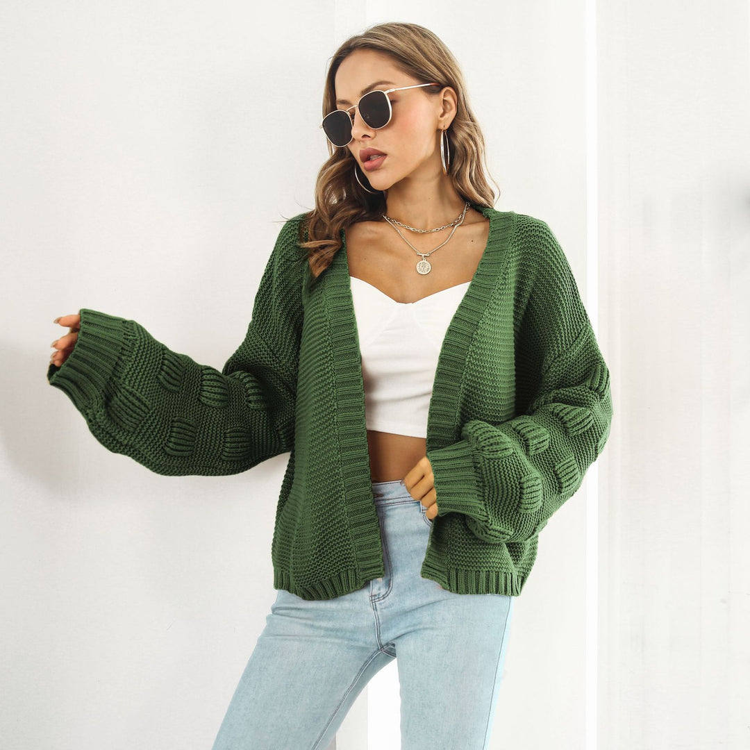 Woman in chunky cable knit puff sleeve cardigan