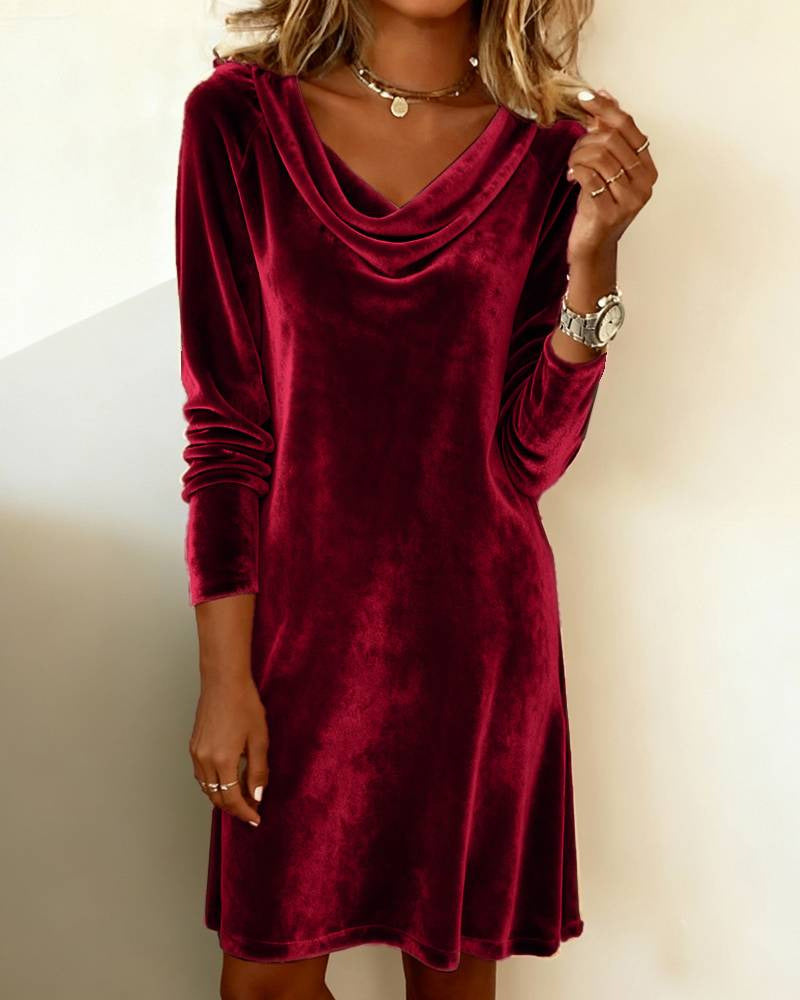 Woman in a velvet cowl neck mini dress