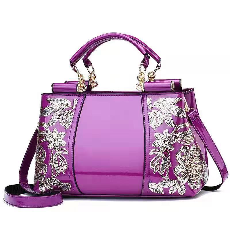 Sequin embroidered patent leather handbag