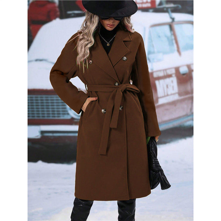 Woman in long belted double-breasted coat
